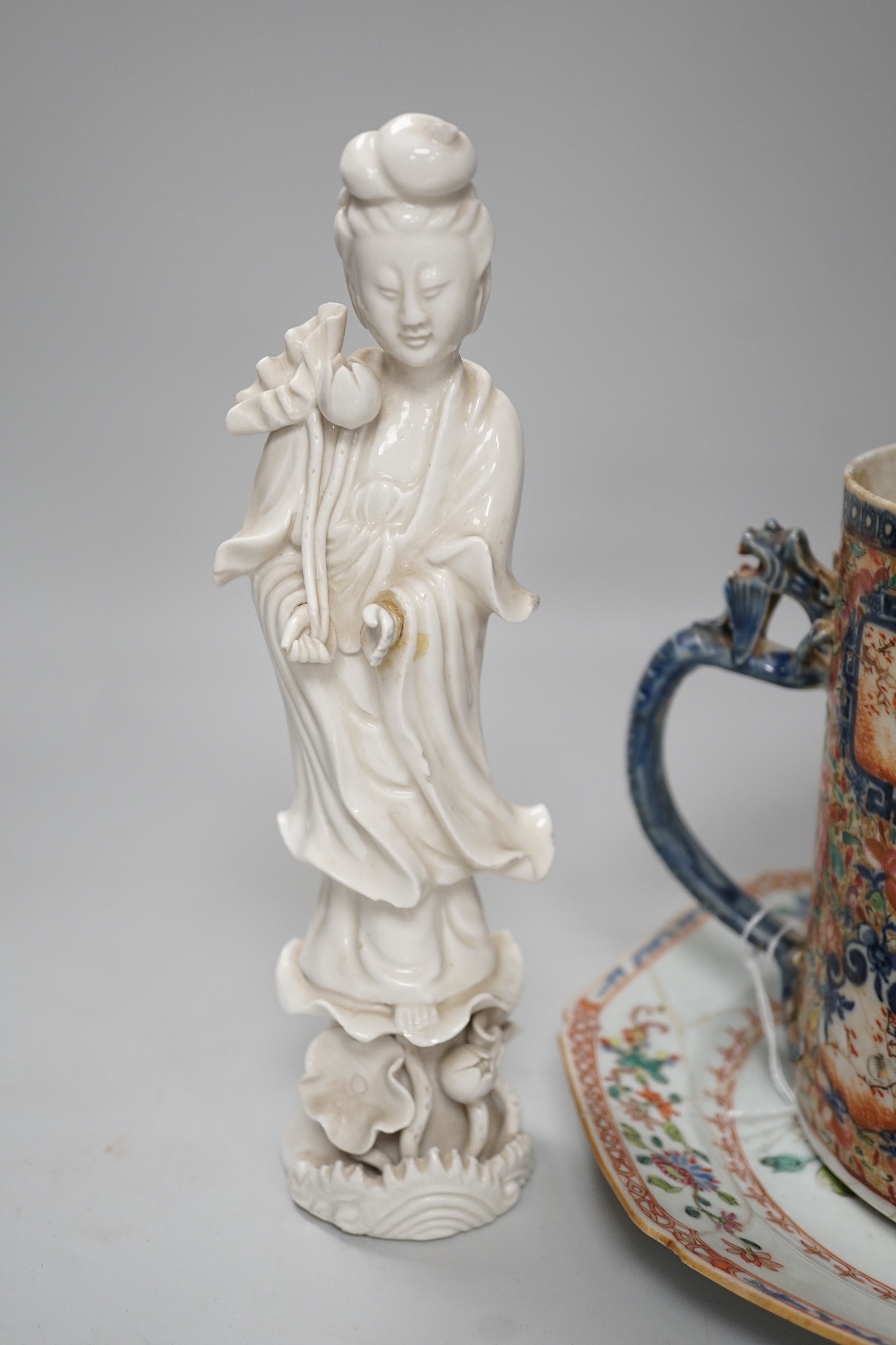 A Chinese figure of blanc de chine, a dragon tea bowl, a saucer, a large tankard, and another Chinese dish, tallest 23cm
